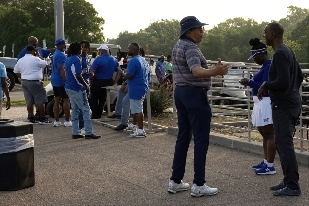 Phi Beta Sigma members and community participants networking at a Tau Zeta Sigma Weekend golf event, promoting fellowship, leadership, and community engagement.